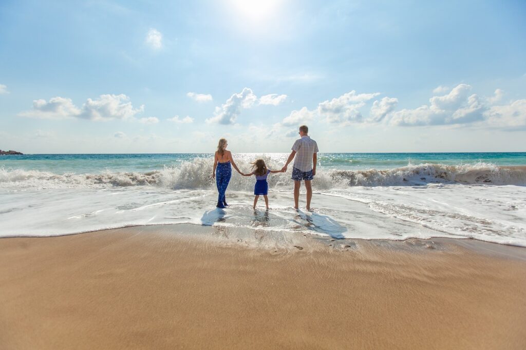 family enjoying a day at the beach with organic sunscreen - Zealandia Organics