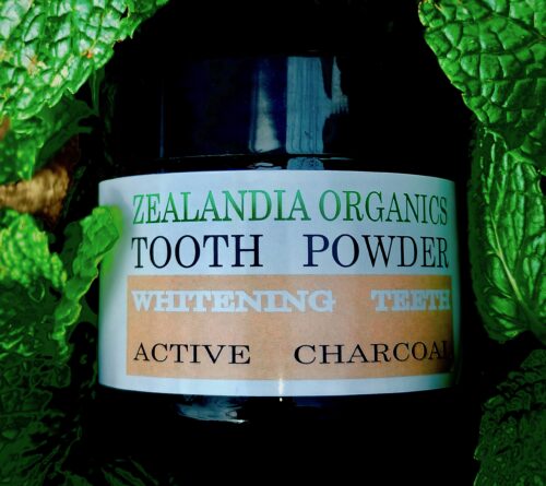 Tooth Powder Coconut Charcoal by Zealandia Organics in amber glass jar with black lid, designed for teeth whitening and toxin removal